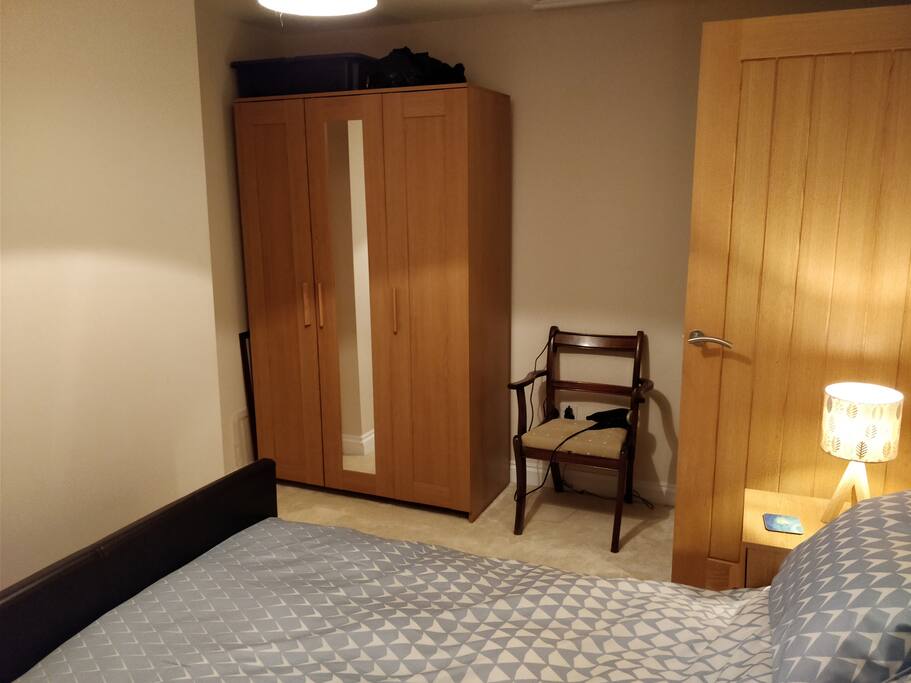Other side of the guest room with wardrobe (with hanging space & coat-hangers)