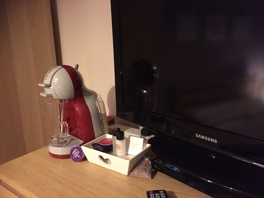 TV in double room with a large assortment of DVDs and coffee machine