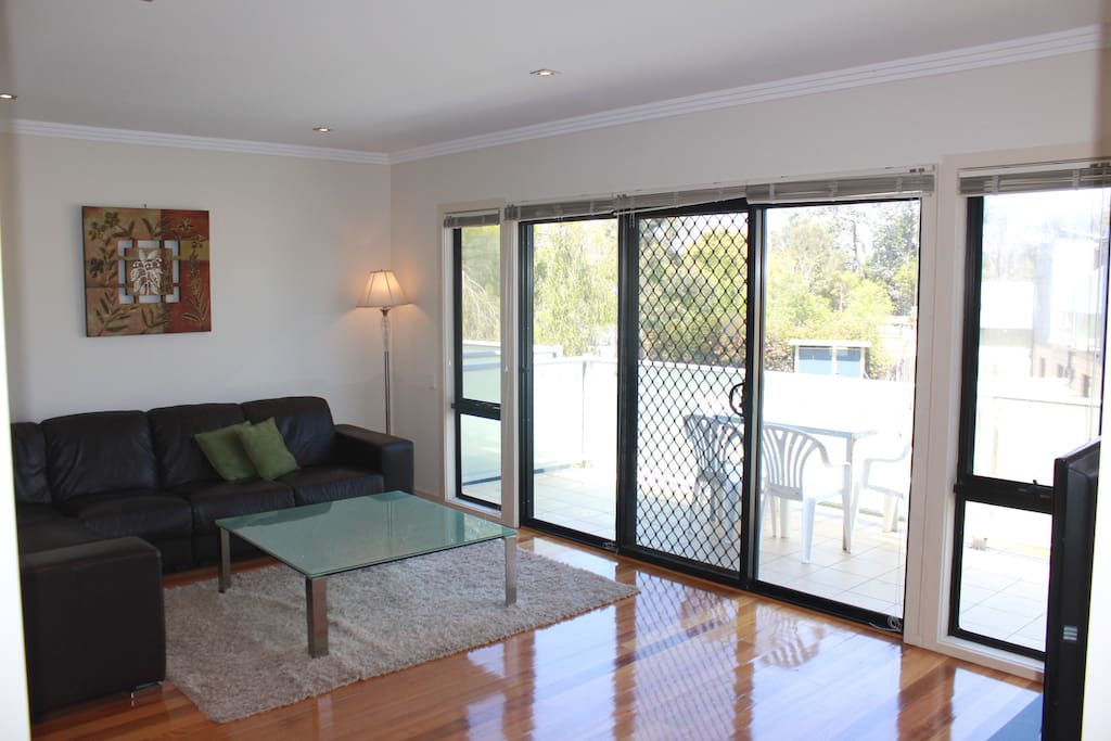 Living room looking out to balcony. Includes security door.