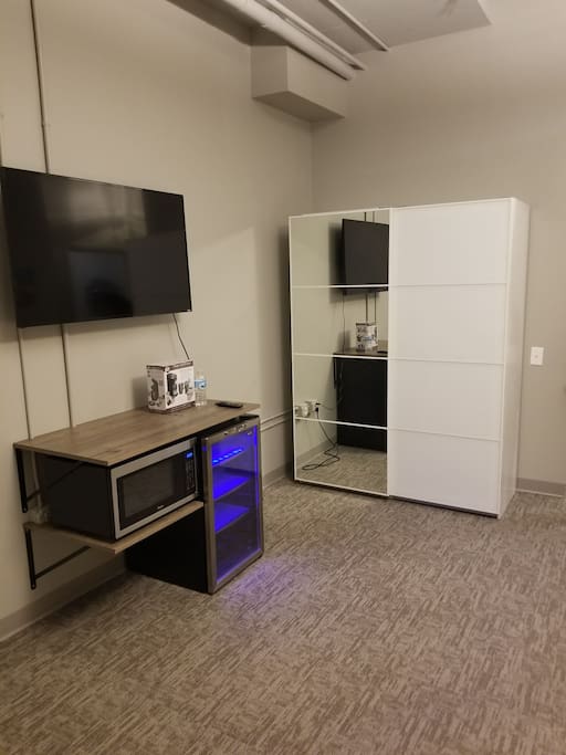 50 inch smart TV, microwave and mini fridge for guest use. Extra large storage closet with full size mirrored door.