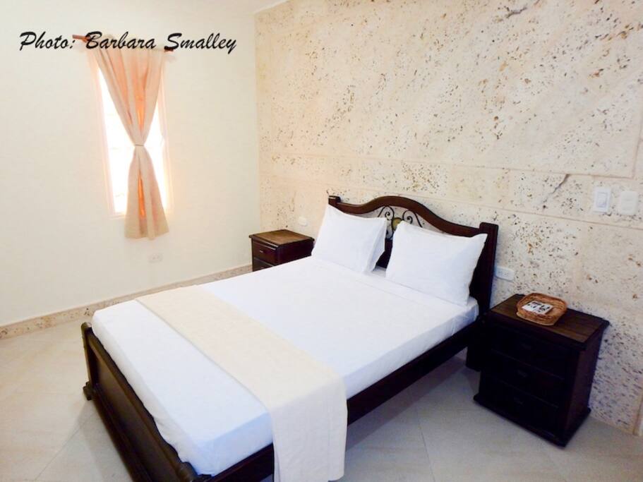 Bedroom #1 with double bed, TV, closet, & en suite bath