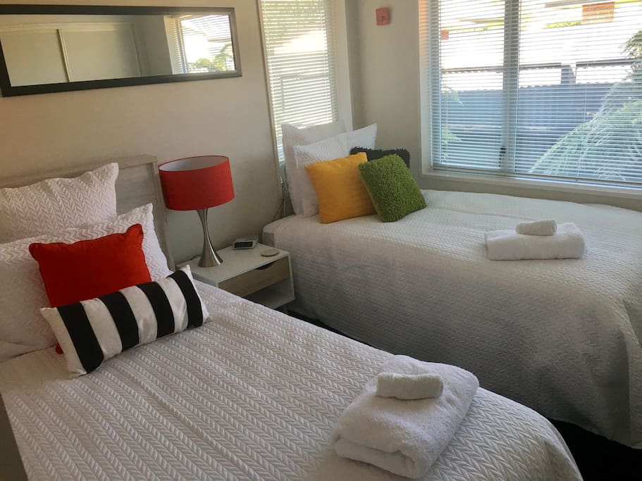 Twin king single beds with quality linen, suitcase racks and spacious wardrobe.