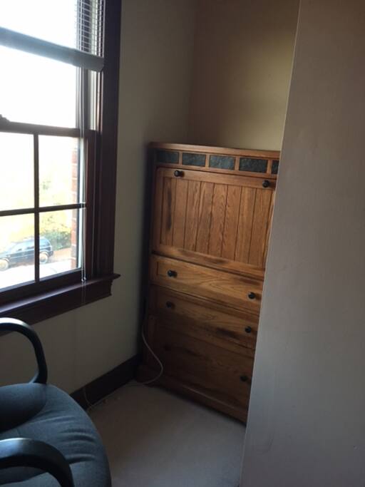 This dresser/desk is tucked back into a corner nook.