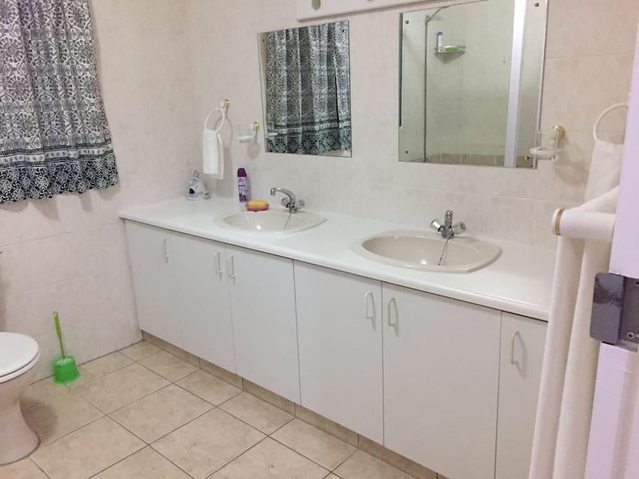 Spacious bathroom with dual basins and mirrors