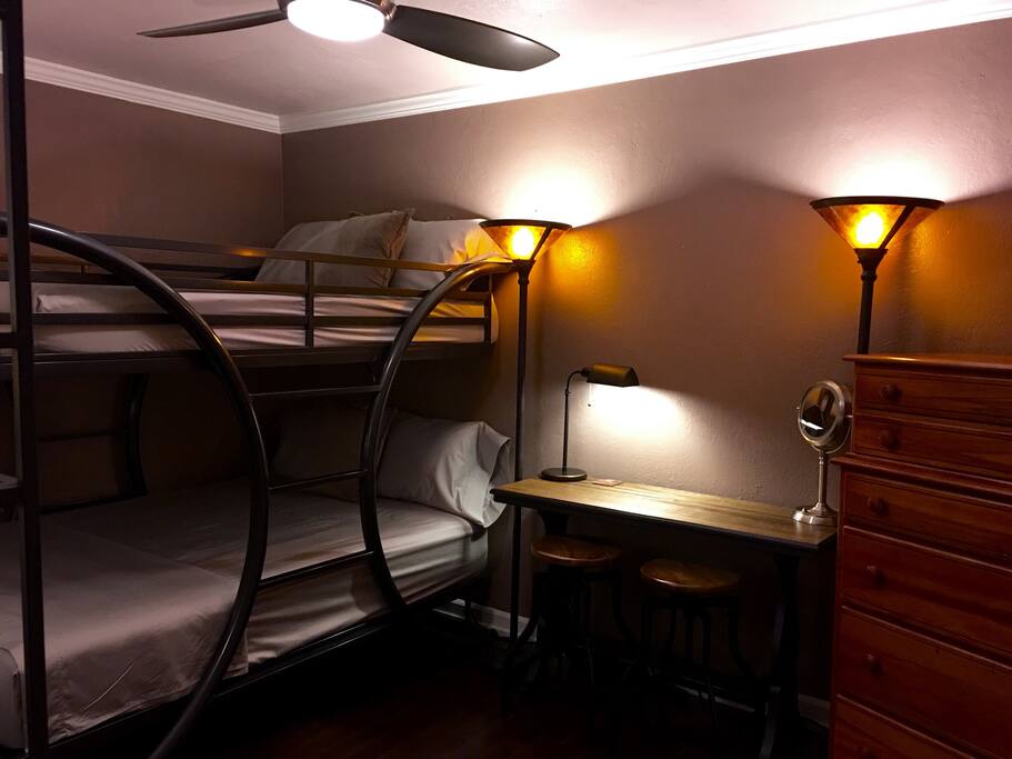 Luxury new gel bamboo mattresses in customized full-size extra-long on a gallery bed with high threadcount sheets; antique study and Grandma's dresser, make-up light. Note that this is a bunk bed arrangement spaciously and sturdily designed for adults. The lower bunk has no head or foot board so if you are extra-long yourself you'll have room to take over. Previous purchasers called the bed a TANK at 400 pounds. It is. The thing doesn't wiggle or make annoying squeaking sounds if your companion on the top bunk suddenly flops over in the middle of the night. So if you are traveling alone? Choose your bed! Just like camp. Only way better.