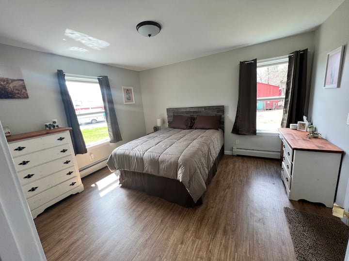 Master bedroom with attached private bath off to the right.  Dresser, desk for working, and large closet with plenty of hanging space and extra storage.  