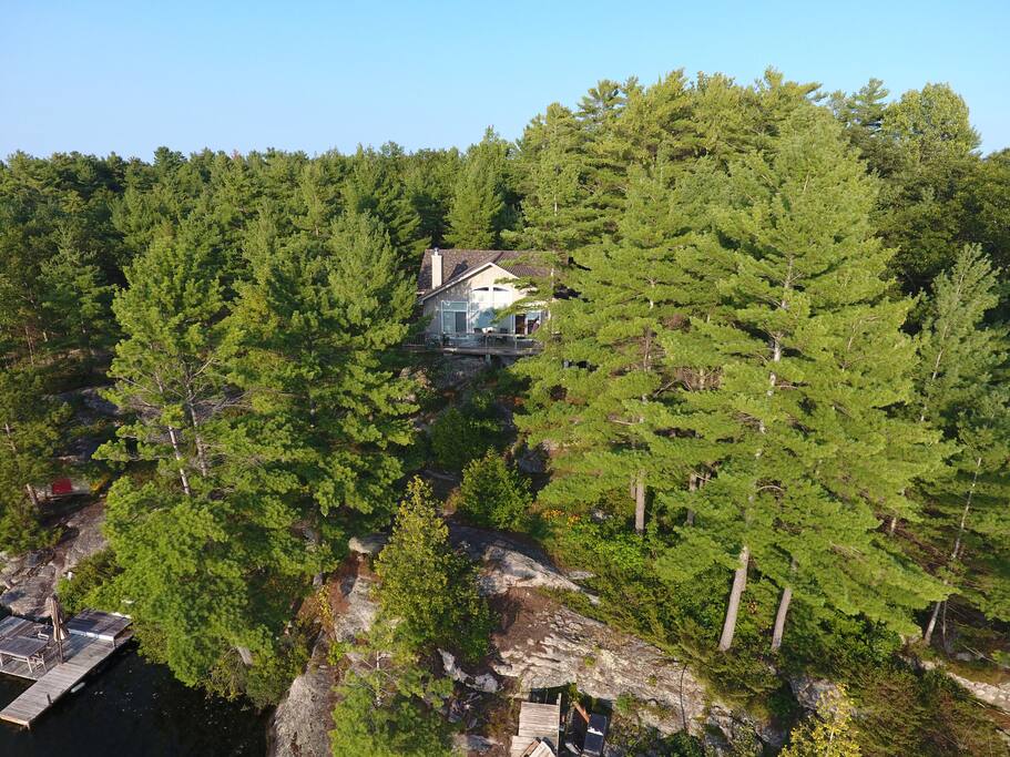 West facing, Outdoor seating includes Dock, water side seating area, and wrap around deck off cottage