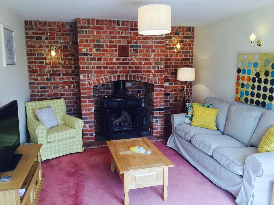 The sitting room with its warm and cosy fire place