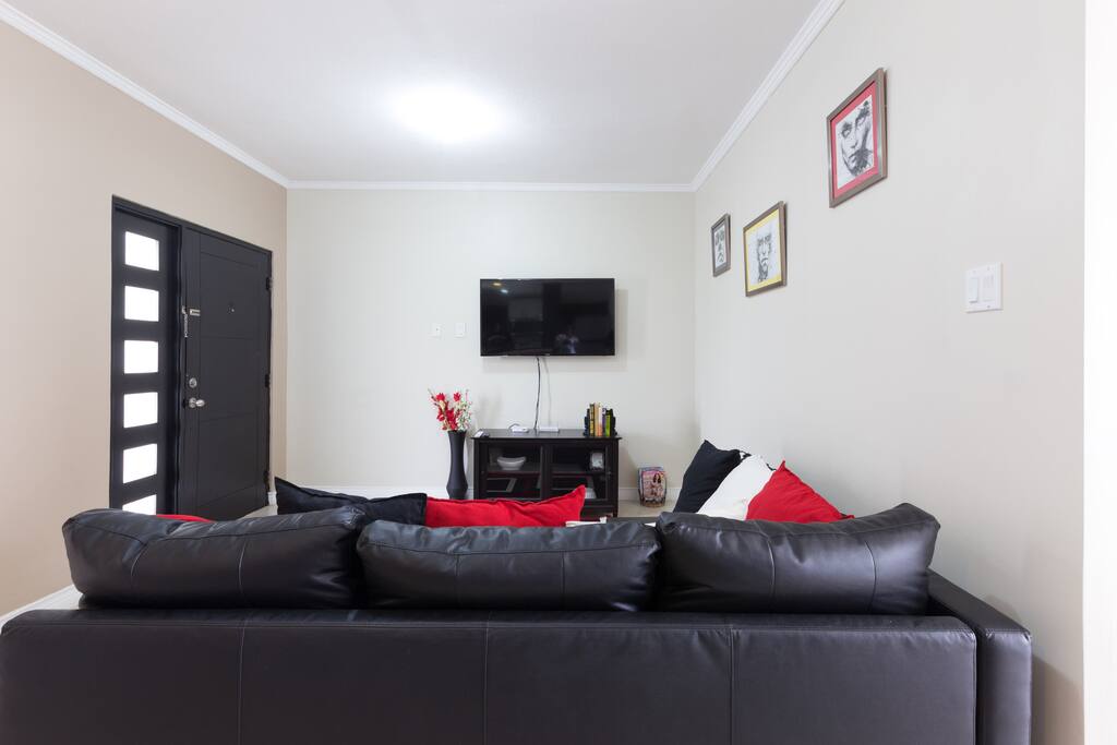 Tastefully decorated living room space with sofa bed, large TV & WIFI.