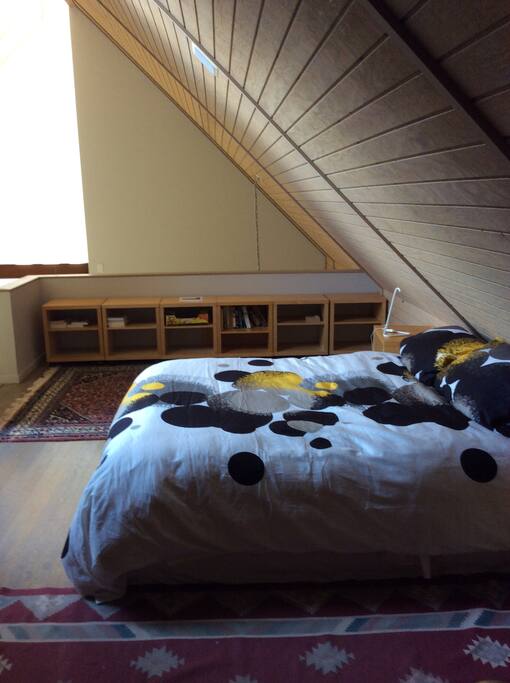 Slope roof bedroom on the top level, water view from window.