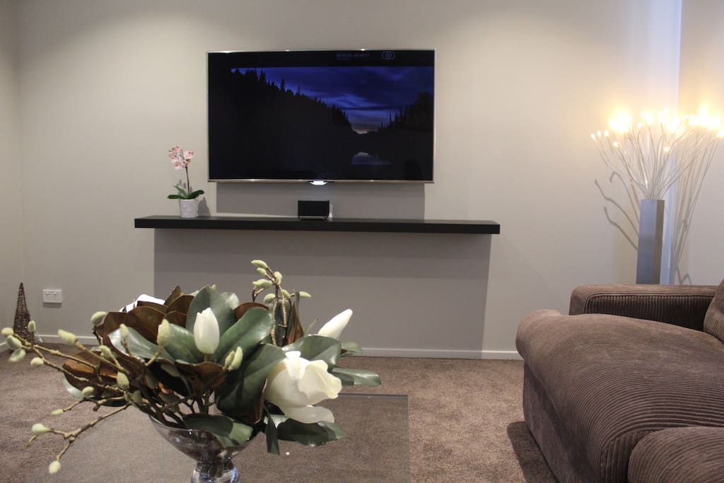 Comfy Theatre room featuring a 65’' SUHD LED TV, 4K Netflix and Foxtel HD and cutting edge “Mass Fidelity Core” audio system