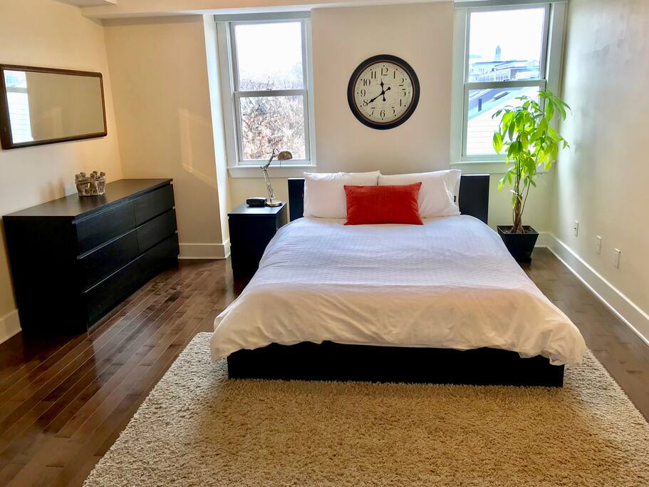Huge master bedroom with queen sized bed on the top floor with views of the Peace Tower on Parliament Hill.