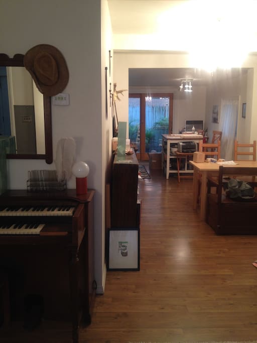 A sliver of the living room. But you'll see a table area and then a breakfast nook in the very back. The piano is out for repairs...