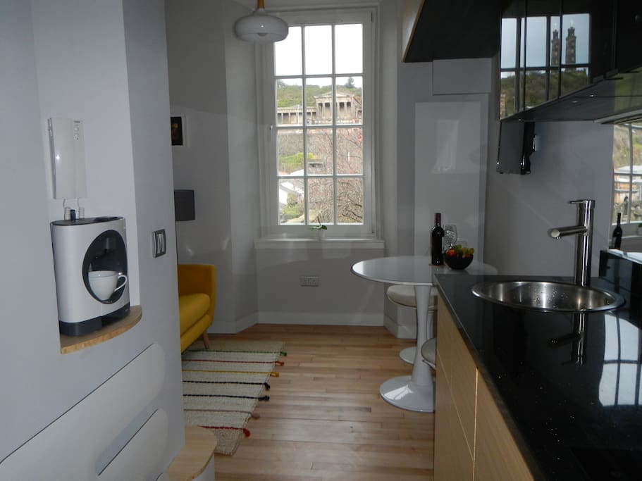 Open plan kitchen has special nooks and crannies, like the alcove for coffee machine (and secure entry phone).