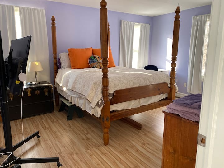 The NW bedroom is at the top of the stairs next to the bathroom. It has an antique canopy queen bed. It is located higher than most beds and has stools 

