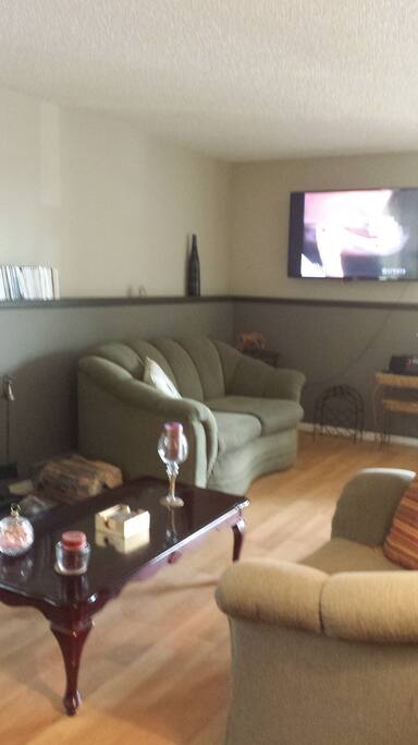 Love seat w/large flat screen TV