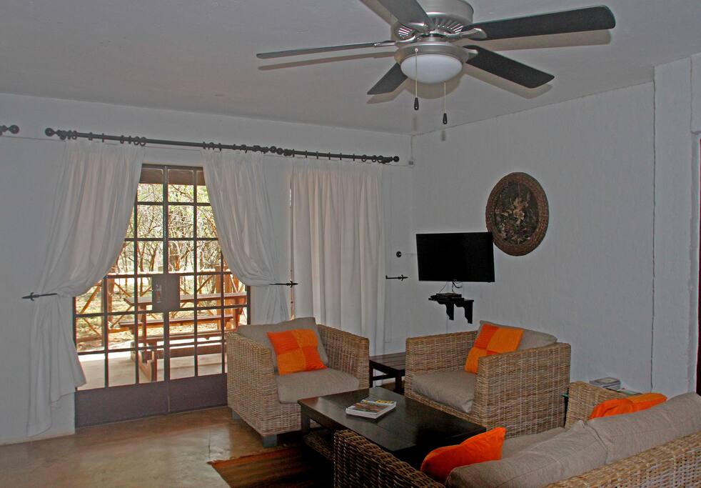The living area looks out on to the patio and and the bushveld beyond.