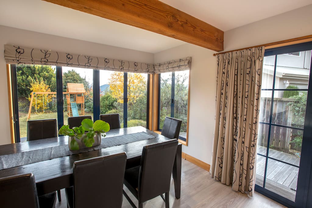 Dinning room windows open to BBQ deck + swing set