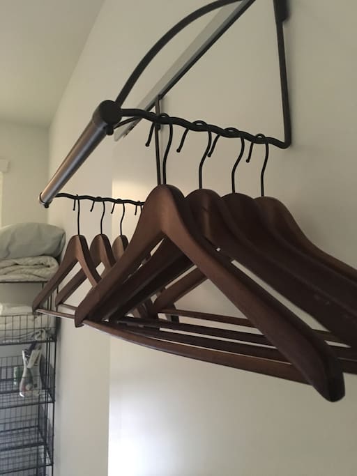 a place to hang clothes and unpack. grid shelving for folded clothes and shoes.