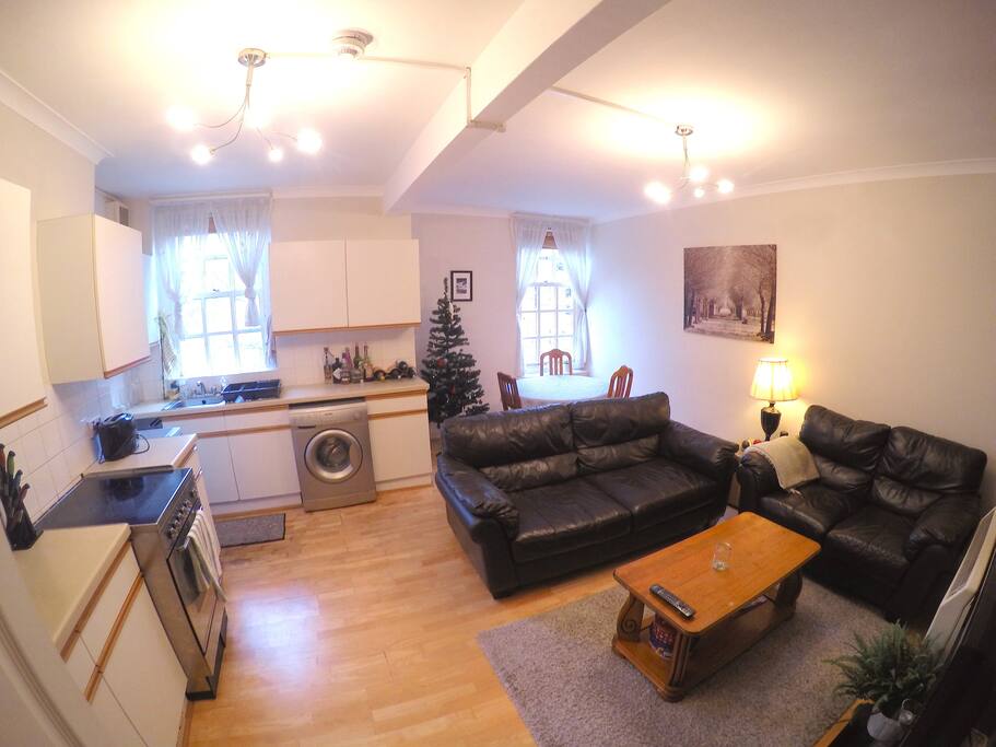 Open plan kitchen and lounge with wide screen TV