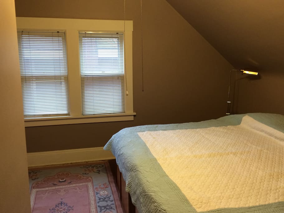 One bedroom features a king sized bed with in-frame drawers for storage.