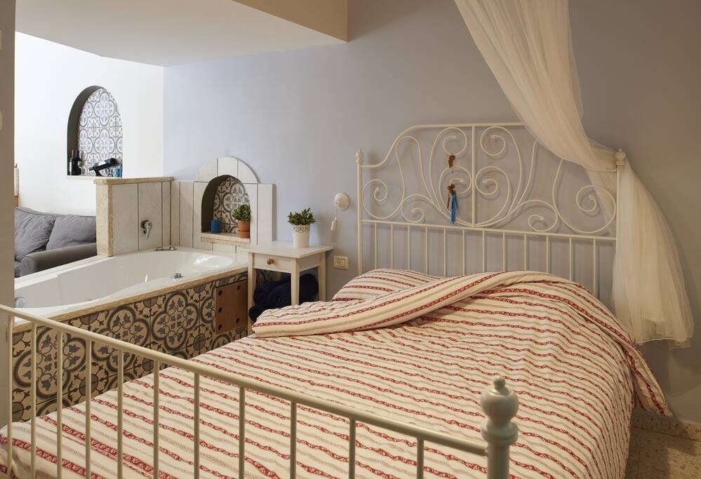 Bedroom with access to jacuzzi.