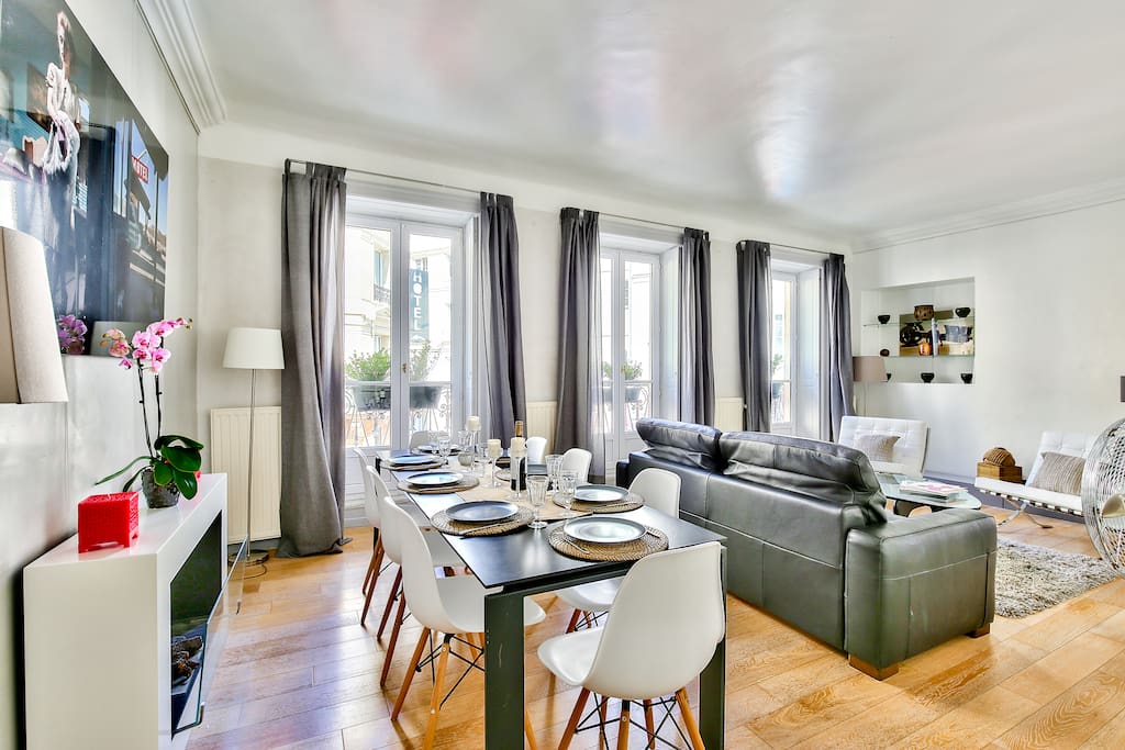 The living room with the dinning table is very sunny