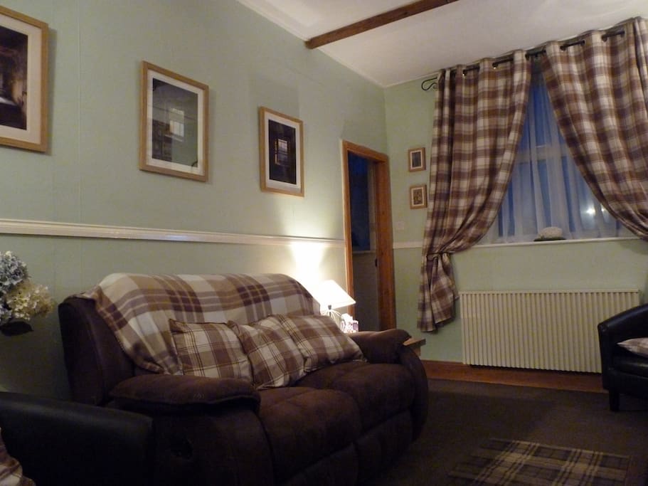 Lounge with comfy recliner sofa and armchairs