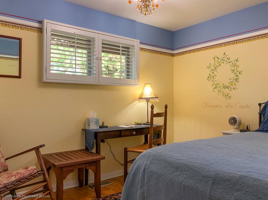 The Poetry Room. A quiet corner room at the back of the house with a queen bed, desk, and closet space.