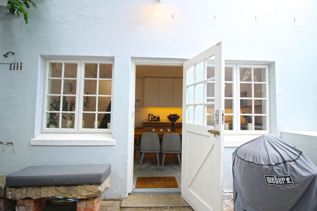 Spacious back courtyard area with bbq and outdoor shower