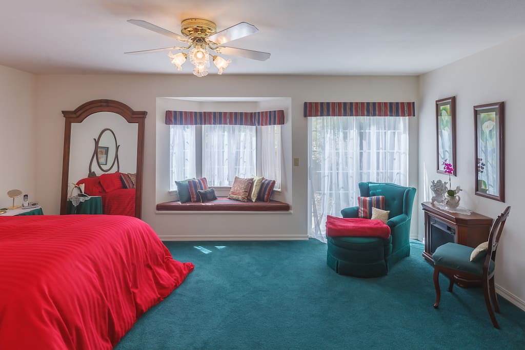 Large bedroom with queen sized bed. TV in room. Small refrigerator, microwave, coffee maker, tea pot and toaster oven.