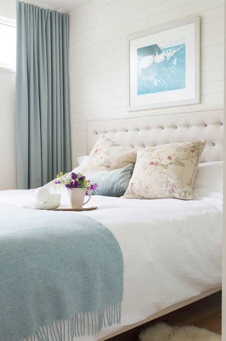 The super king-size bed in the main bedroom has a padded headboard and is super comfy.