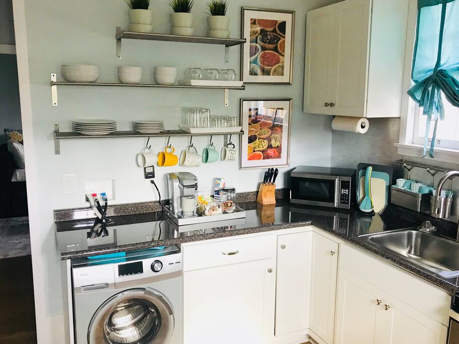 Kitchen opens to hallway leading to bathroom and bedroom