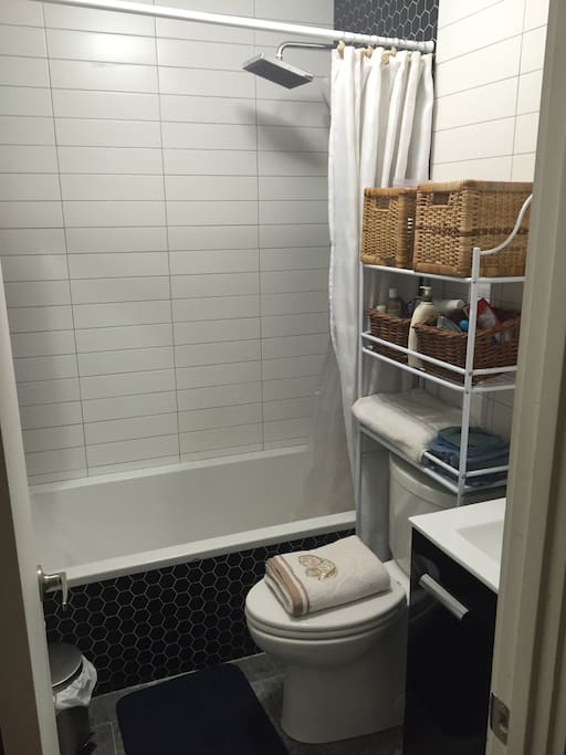 Full-size tub under a rain-shower.