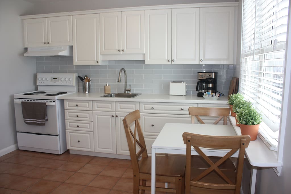 Enjoy a meal at the kitchen table while looking out the large window to the backyard.