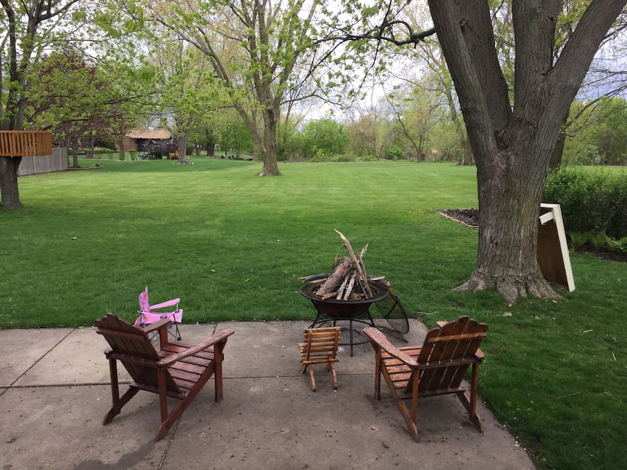 Huge beautiful backyard with lake at end of it.