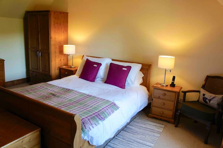 Main bedroom, overlooks the garden and view of Cateran Trail in the distance, with king-size bed and newly refurbished en-suite shower room with WC