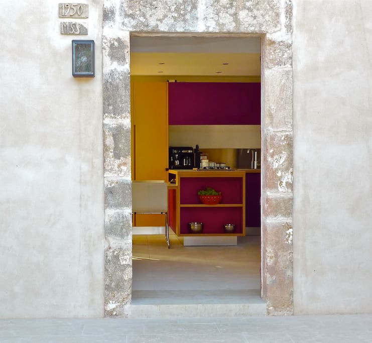 View through Casa Modesta's front door to the stunning bespoke kitchen in warm Moroccan inspired hues.