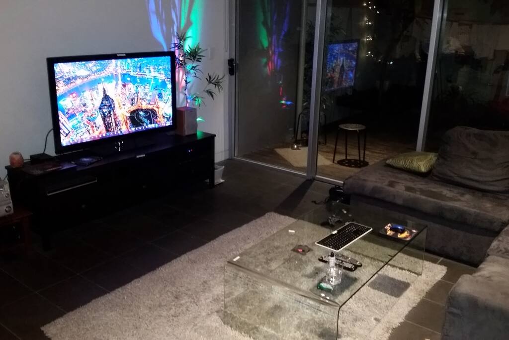 Lounge room with giant bean bags, 5 seater sofa and netflix
