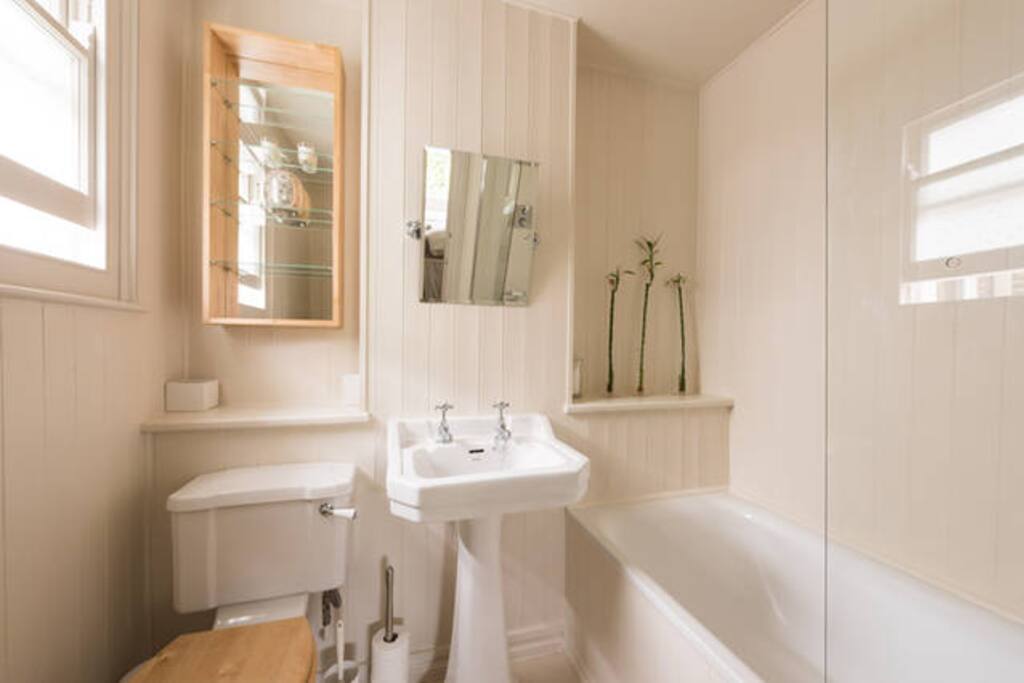 Ensuite bathroom with large comfortable bath and overhead shower.