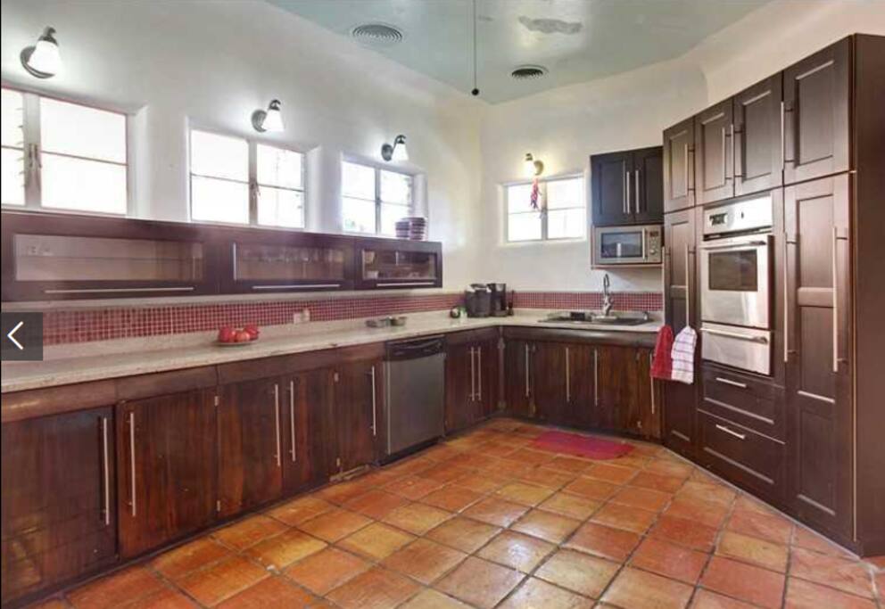 Chefs kitchen with pots, pans, dishes, utensils,
