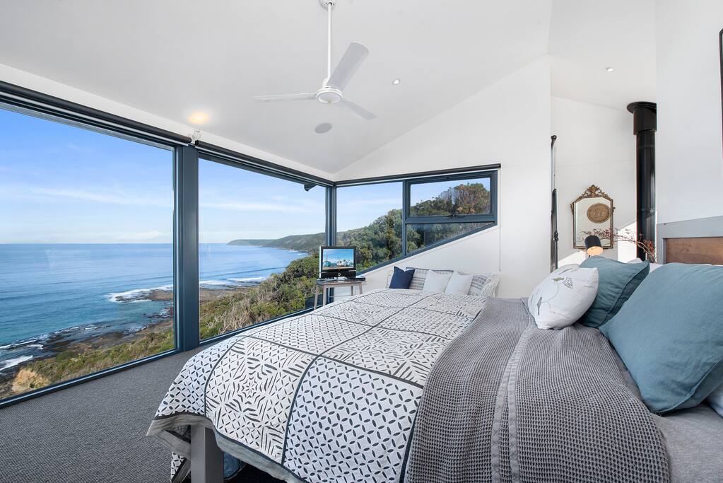 master bedroom with amazing ocean views, queen bed, TV, gas fireplace, ensuite and private courtyard.