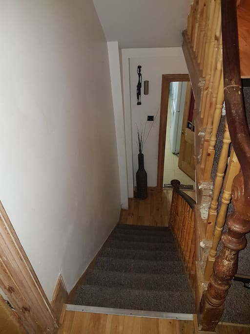 Staircase leading to kitchen amd bathroom area
