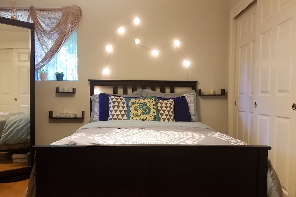 Full-length mirror, full-size bed, and paper reading lanterns.