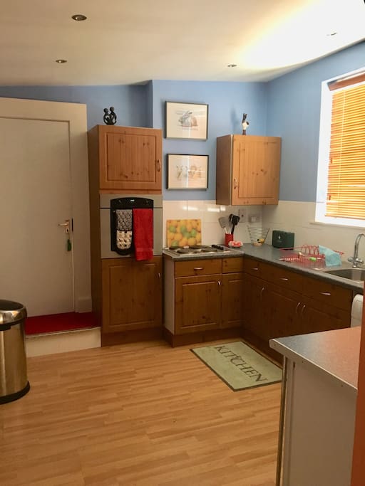 The kitchen, through archway from bedroom