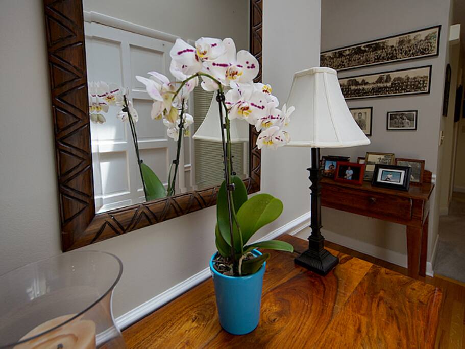 Flowers typically help to greet you beneath a skylight in the bright foyer