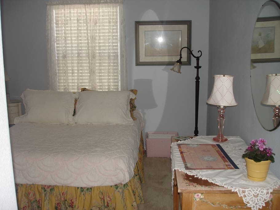 Cheerful blue room with comfortable full size bed.