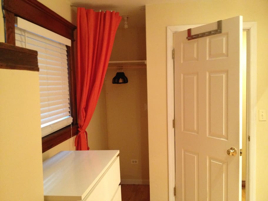 Open wardrobe, and door with lock on inside.