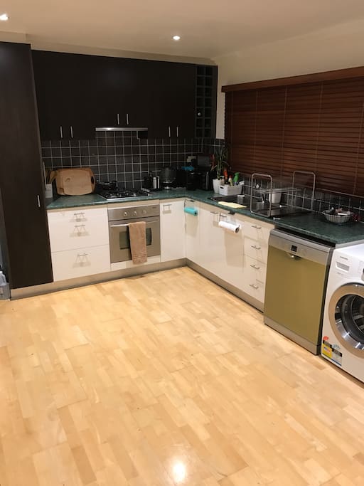 Open plan kitchen with European laundry