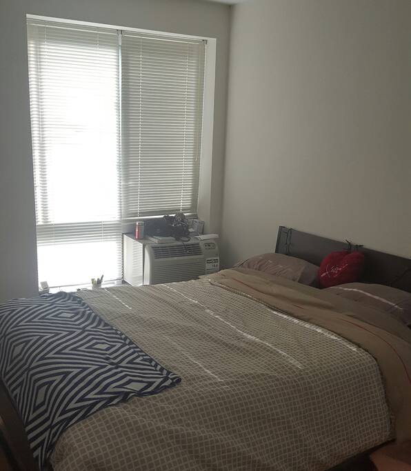 Bedroom in which you'll be staying.
Queen size Bed, huge closet space, air con in room, chair in room.